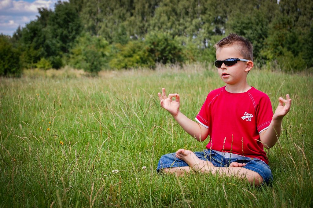 live in the moment - boy meditating