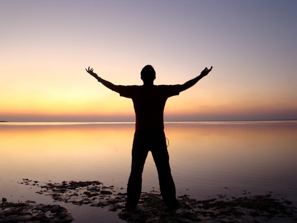 20 Habits To Improve Your Life image of man on beach