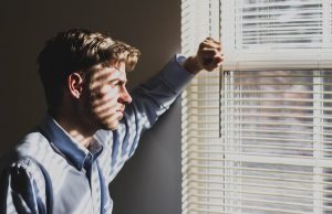 Postnatal depression in men - image of man in window