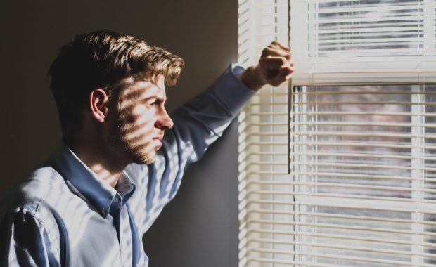 Postnatal depression in men - image of man in window